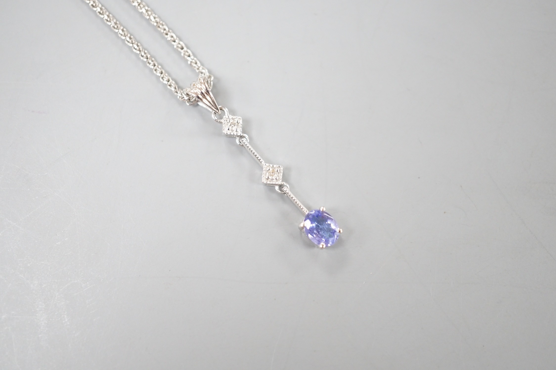 A modern Italian 705 white metal tanzanite and diamond set three stone pendant necklace, 48cm, gross weight 4 grams.